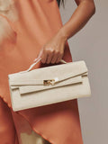 Beige faux suede top handle clutch bag with gold chain-link turn clasp