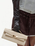Beige structured mini bag side view with rounded gusset and arched handle