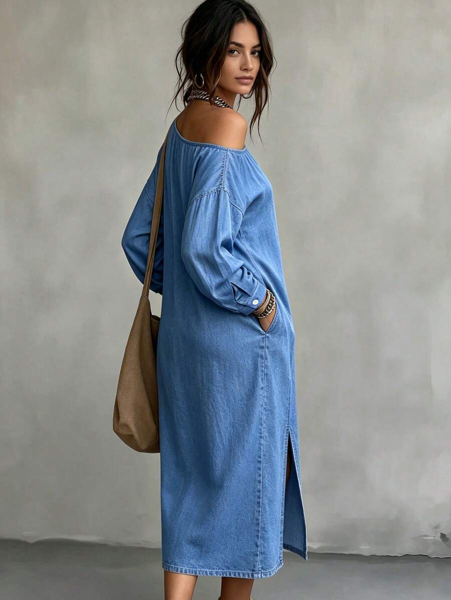 Side view of loose blue denim midi dress with dropped shoulder and front split