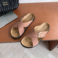 4 media show dusty pink and beige suede-look crisscross slide sandals with gold side buckle, tan molded footbed, stitched welt look, black chunky outsole. image 4
