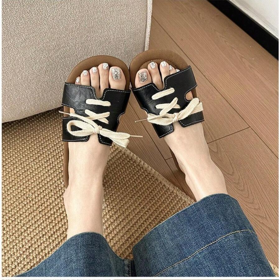 7 media show lace-up flat slide sandals in cream, black, metallic silver and cream black polka dots with H-cut wide vamp strap, sneaker-lace detail, open toe, backless slip-on, brown padded METWO footbed and thin black outsole. image 2