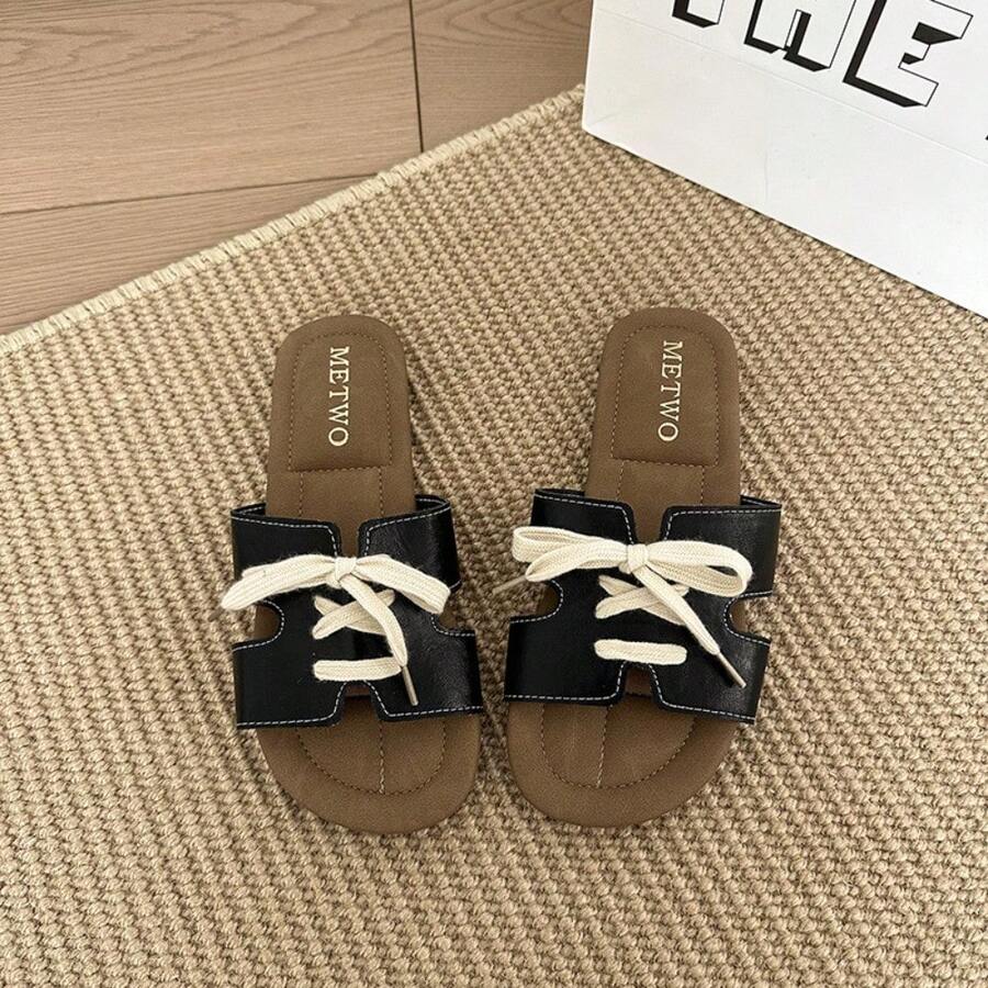 7 media show lace-up flat slide sandals in cream, black, metallic silver and cream black polka dots with H-cut wide vamp strap, sneaker-lace detail, open toe, backless slip-on, brown padded METWO footbed and thin black outsole. image 3