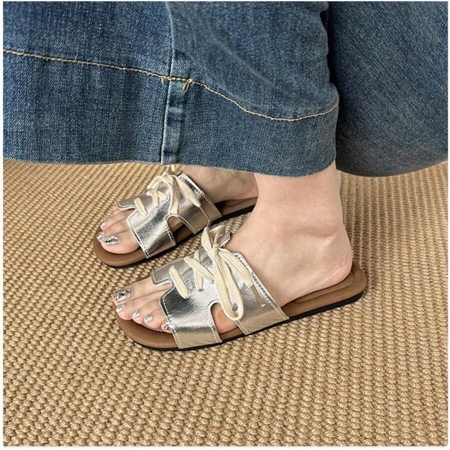 7 media show lace-up flat slide sandals in cream, black, metallic silver and cream black polka dots with H-cut wide vamp strap, sneaker-lace detail, open toe, backless slip-on, brown padded METWO footbed and thin black outsole. image 4
