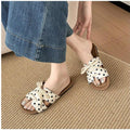 7 media show lace-up flat slide sandals in cream, black, metallic silver and cream black polka dots with H-cut wide vamp strap, sneaker-lace detail, open toe, backless slip-on, brown padded METWO footbed and thin black outsole. image 6