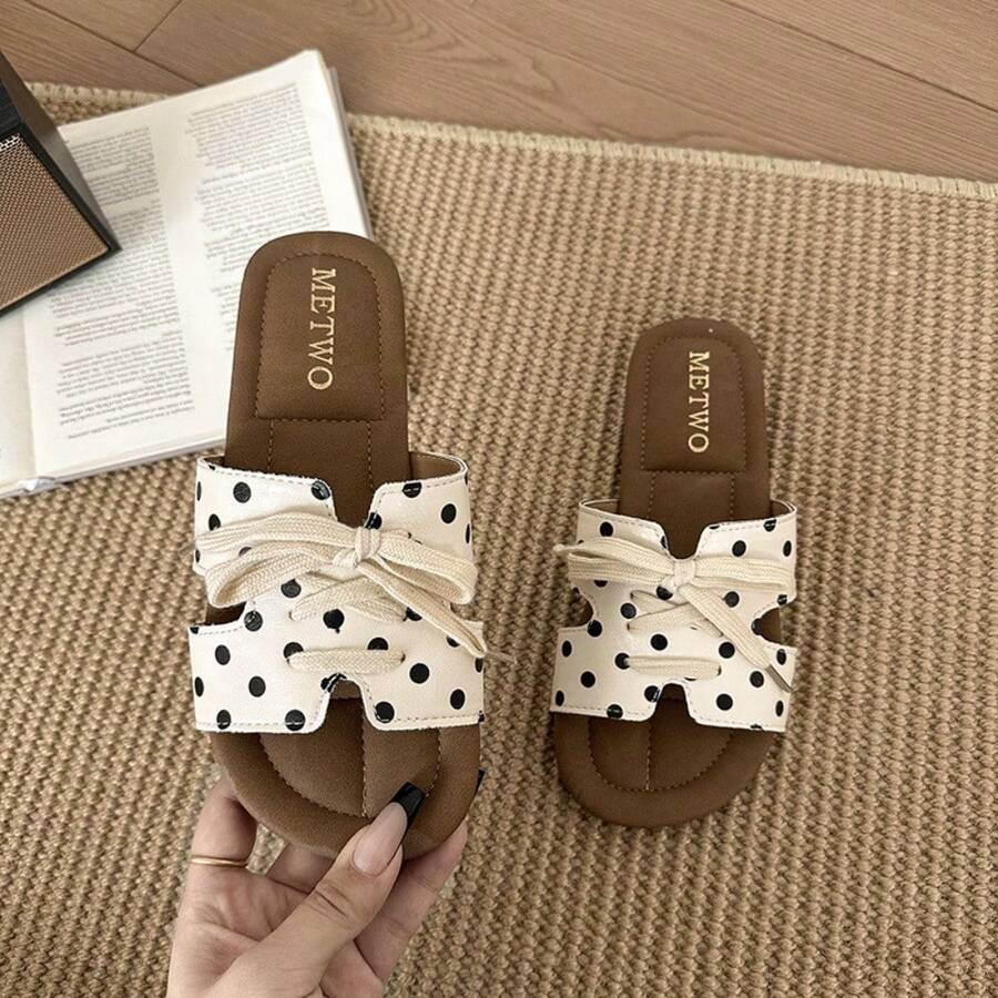 7 media show lace-up flat slide sandals in cream, black, metallic silver and cream black polka dots with H-cut wide vamp strap, sneaker-lace detail, open toe, backless slip-on, brown padded METWO footbed and thin black outsole. image 7