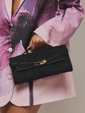 Black faux suede top handle clutch bag with gold turn lock clasp