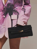 Black structured mini bag side view showing rounded gusset and handle