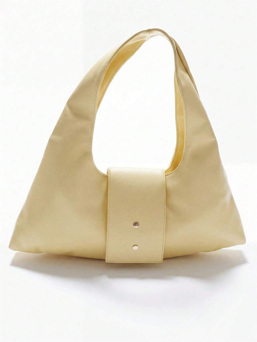 Detail view of pale yellow hobo bag showing two studs and smooth finish