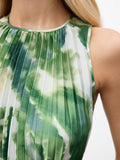 Detail view of green tie-dye print and pleated fabric at the sleeveless halter neckline