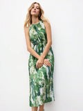 Three-quarter front view of green and white tie-dye pleated midi dress with waist belt and flared skirt