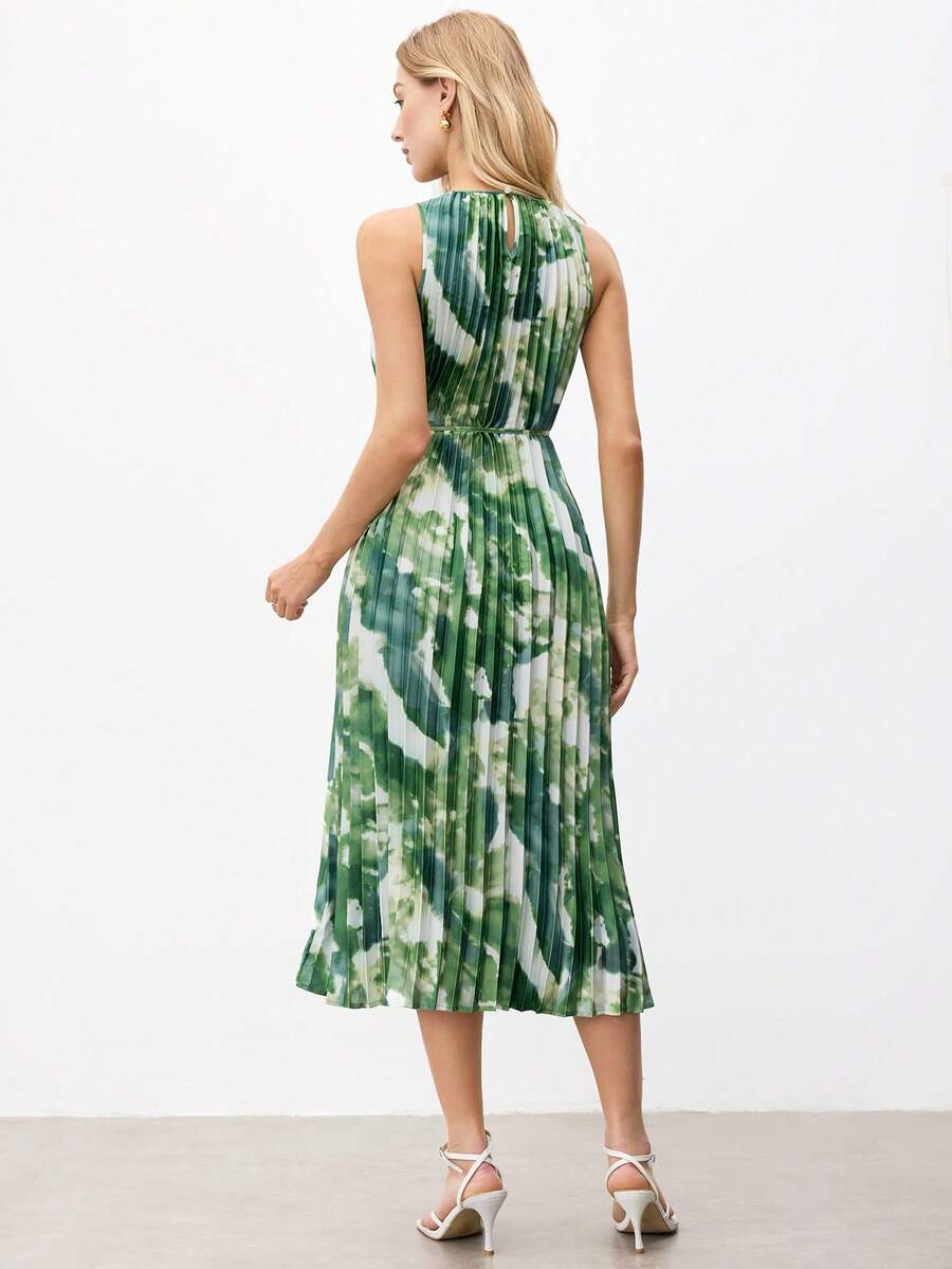 Back view of pleated green tie-dye midi dress showing halter keyhole closure and defined waist