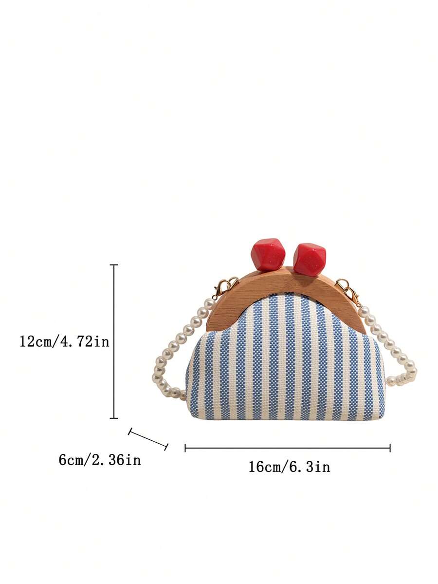 Size guide view of striped mini crossbody bag with red kiss lock closure