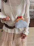 Worn crossbody view of blue striped mini pouch bag with pearl shoulder strap