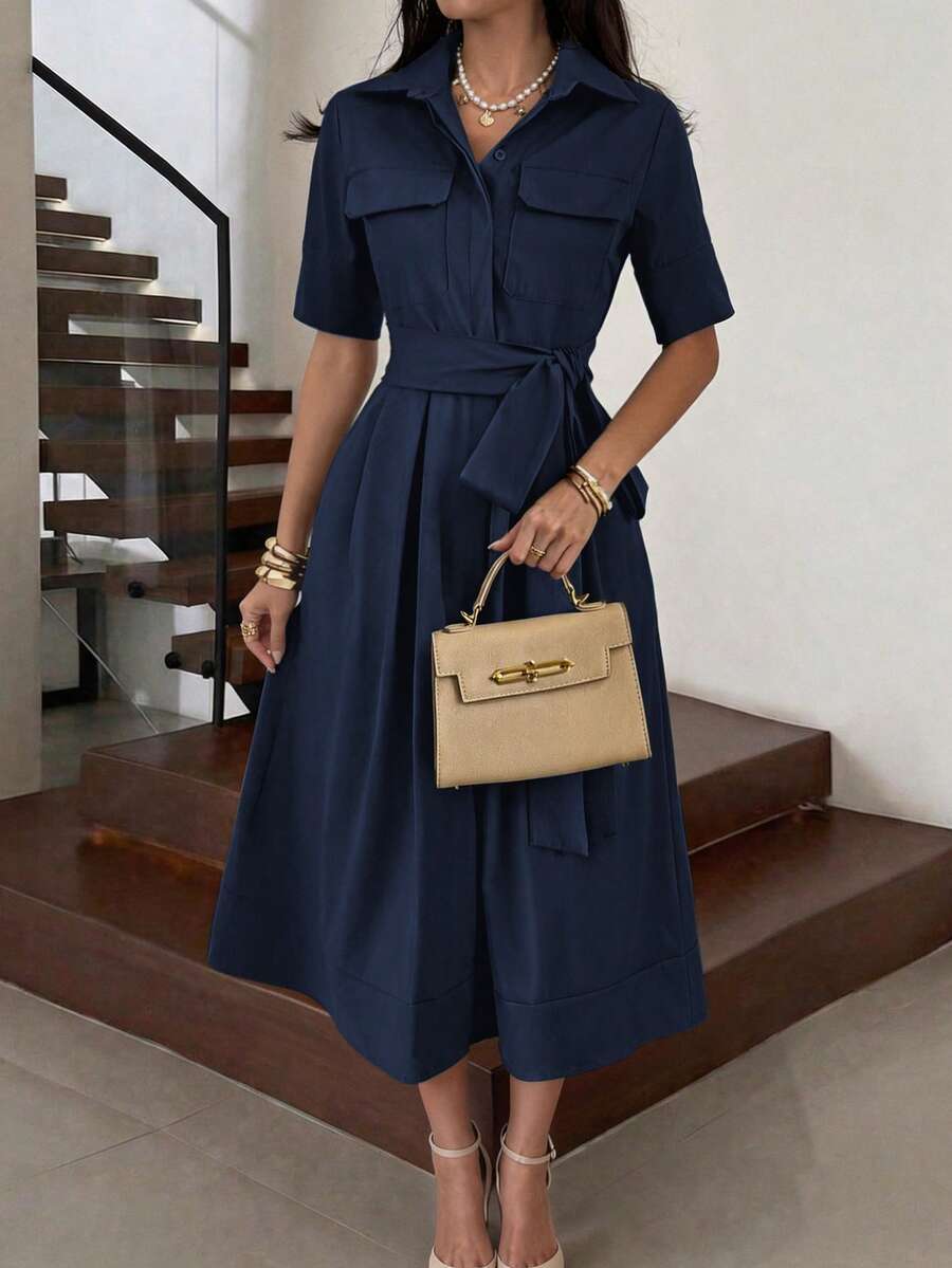 Front view of navy blue collared belted button front midi dress