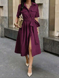 Burgundy A-line midi dress styled with handbag and heels