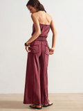 Back view of deep burgundy strapless jumpsuit with rear patch pockets and wide legs