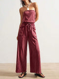 Front view of deep burgundy strapless wide-leg jumpsuit with drawstring waist and pockets