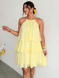 Full front view of pale yellow tiered halter dress