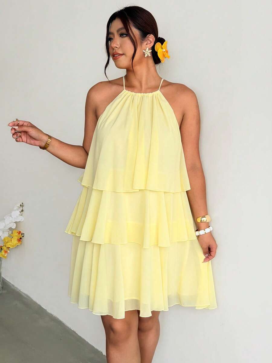 Full front view of pale yellow tiered halter dress