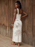 Back view of ivory palm print one-shoulder maxi dress with open back