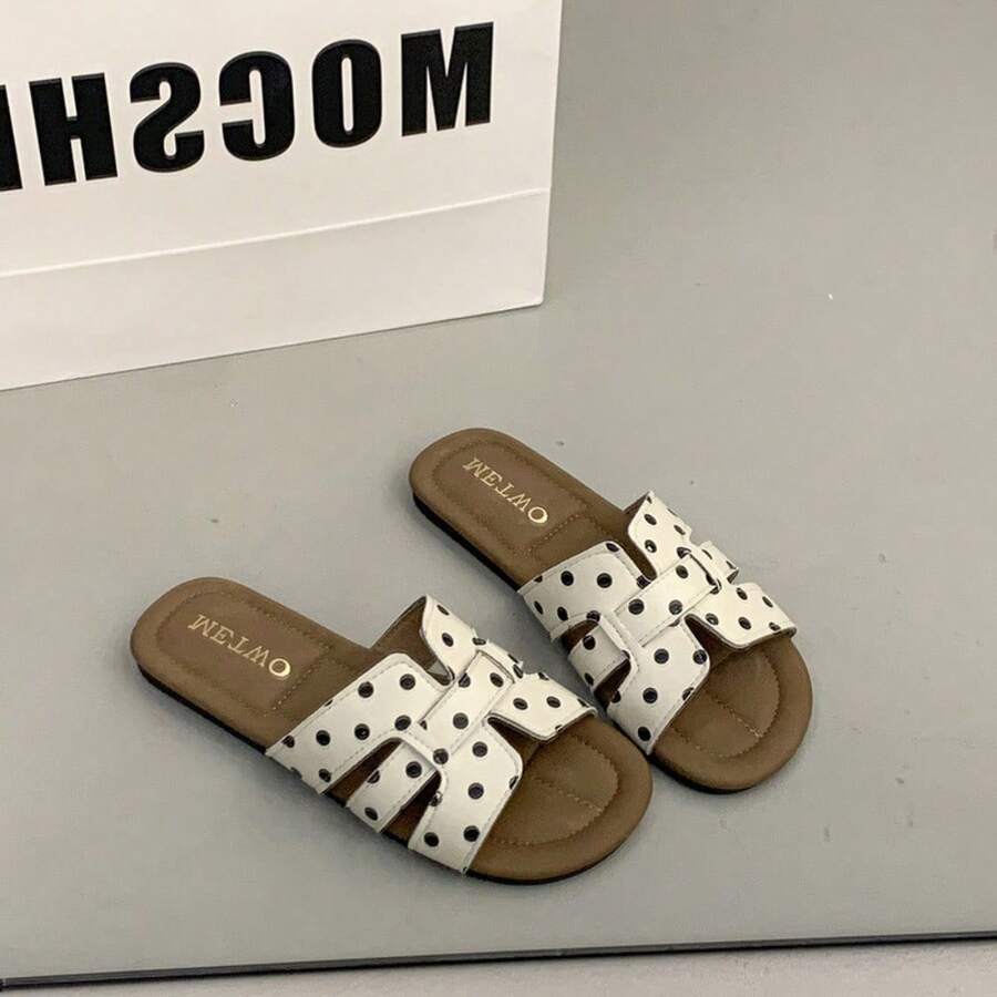 4 media show woven-look flat slide sandals in cream with black dots and black with white dots, interlaced H-style vamp straps, open cutouts, backless slip-on, brown padded METWO footbed and thin black outsole. image 1