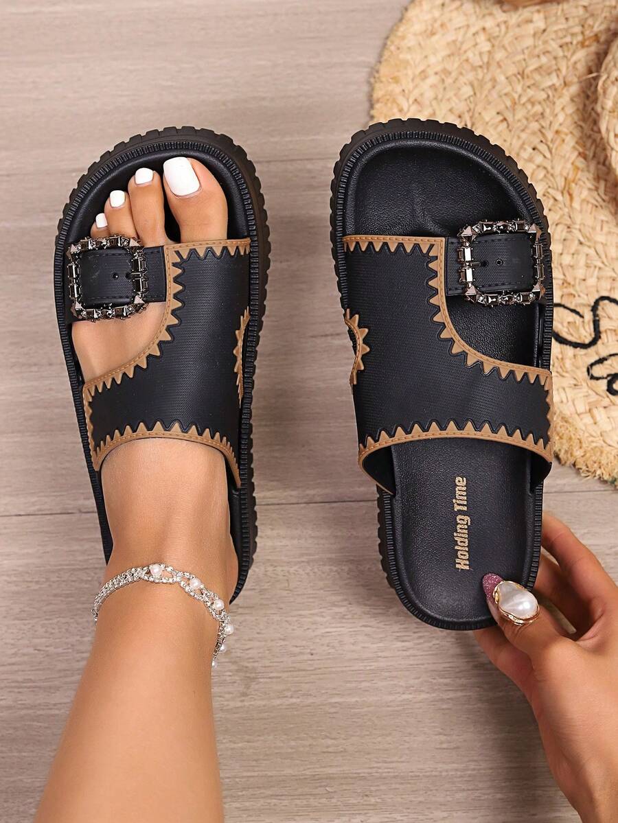 Top view of black slip-on slide sandals with Walking Time footbed text