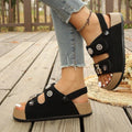 4 media show cream/beige and black platform slingback comfort sandals with two wide cutout front straps, back heel strap snap button, rhinestone flower studs, pearl-like studs, teddy-bear charm, thick tan platform and black ridged tread. image 4