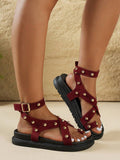 Side view of burgundy studded platform sandals with open toes