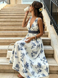 White and navy floral V-neck maxi dress with dark waistband, seated view