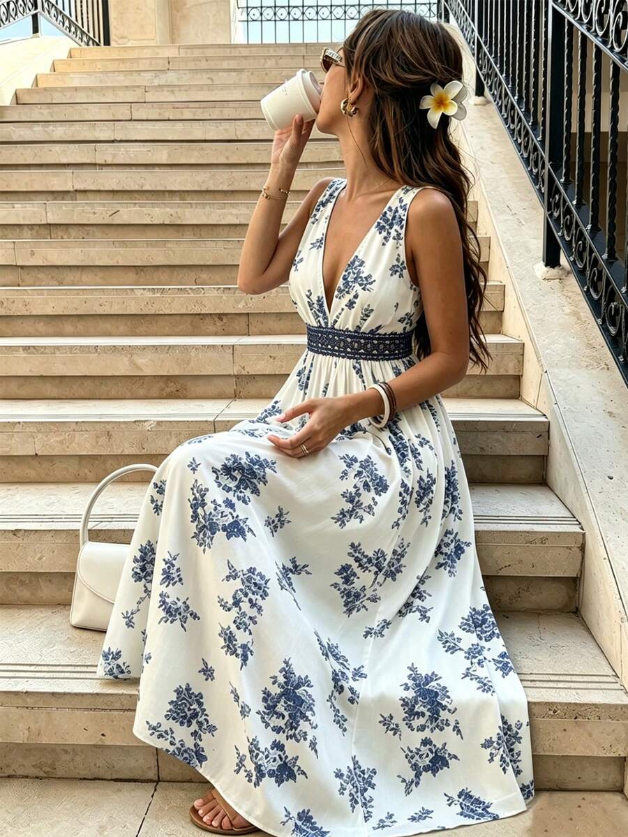 White and navy floral V-neck maxi dress with dark waistband, seated view