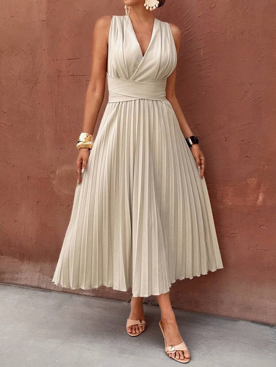 Close view of apricot sleeveless dress with wrap V-neck and pleated skirt