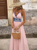 Front view of pink boho halter maxi dress with geometric high waist and flared skirt