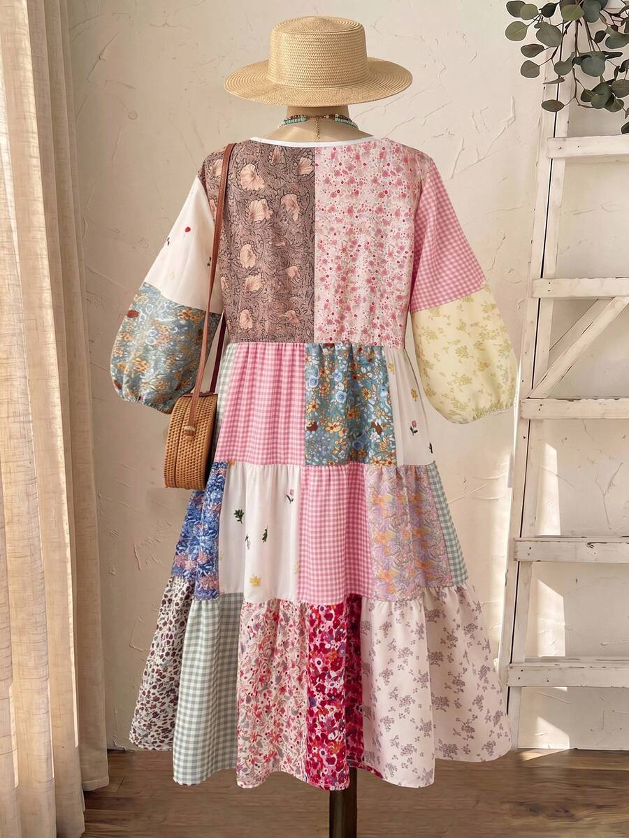 Front view of pastel floral gingham patchwork dress with round neck and tiered skirt