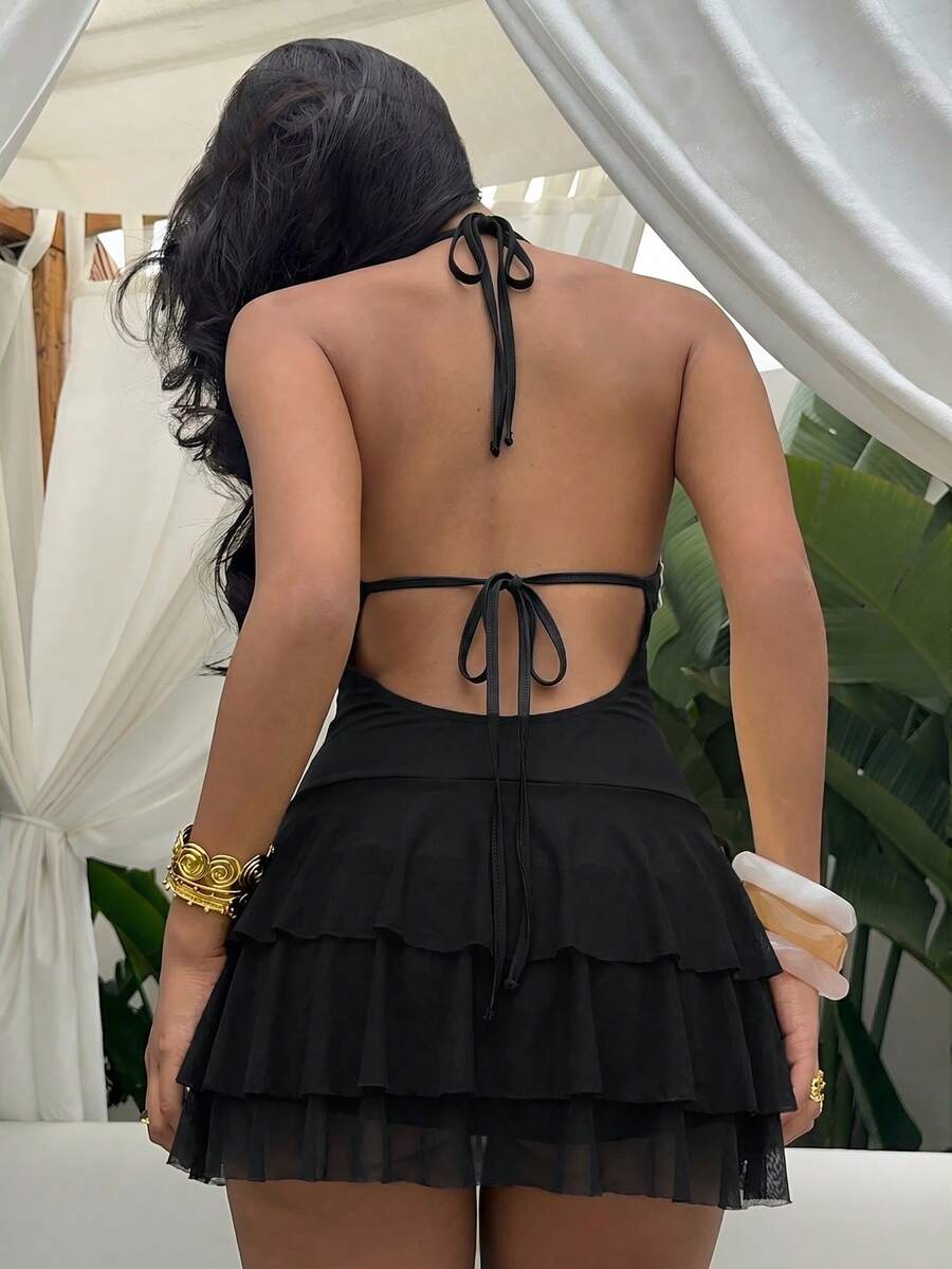 Styled view of shell trim halter ruffle mini dress showing visible color, trim, and silhouette