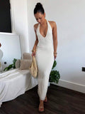 Back full body view of white open back halter maxi dress