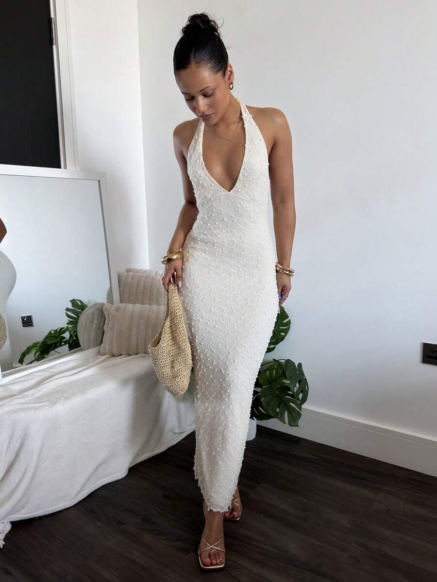 Back full body view of white open back halter maxi dress