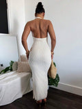 Close front view of white dotted textured halter dress with deep V neckline