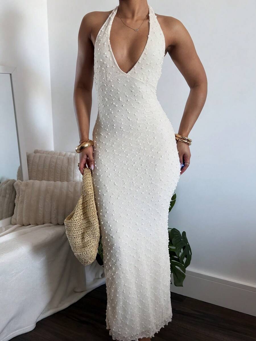Side front view of white bodycon column maxi dress with textured hem