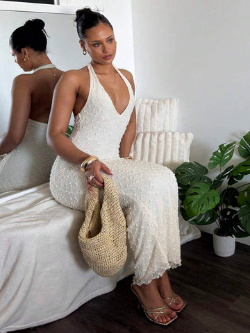 Front full body view of white textured halter V neck maxi dress