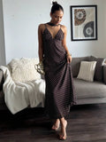 Front view of brown polka dot slip maxi dress with deep V neckline and neck scarf