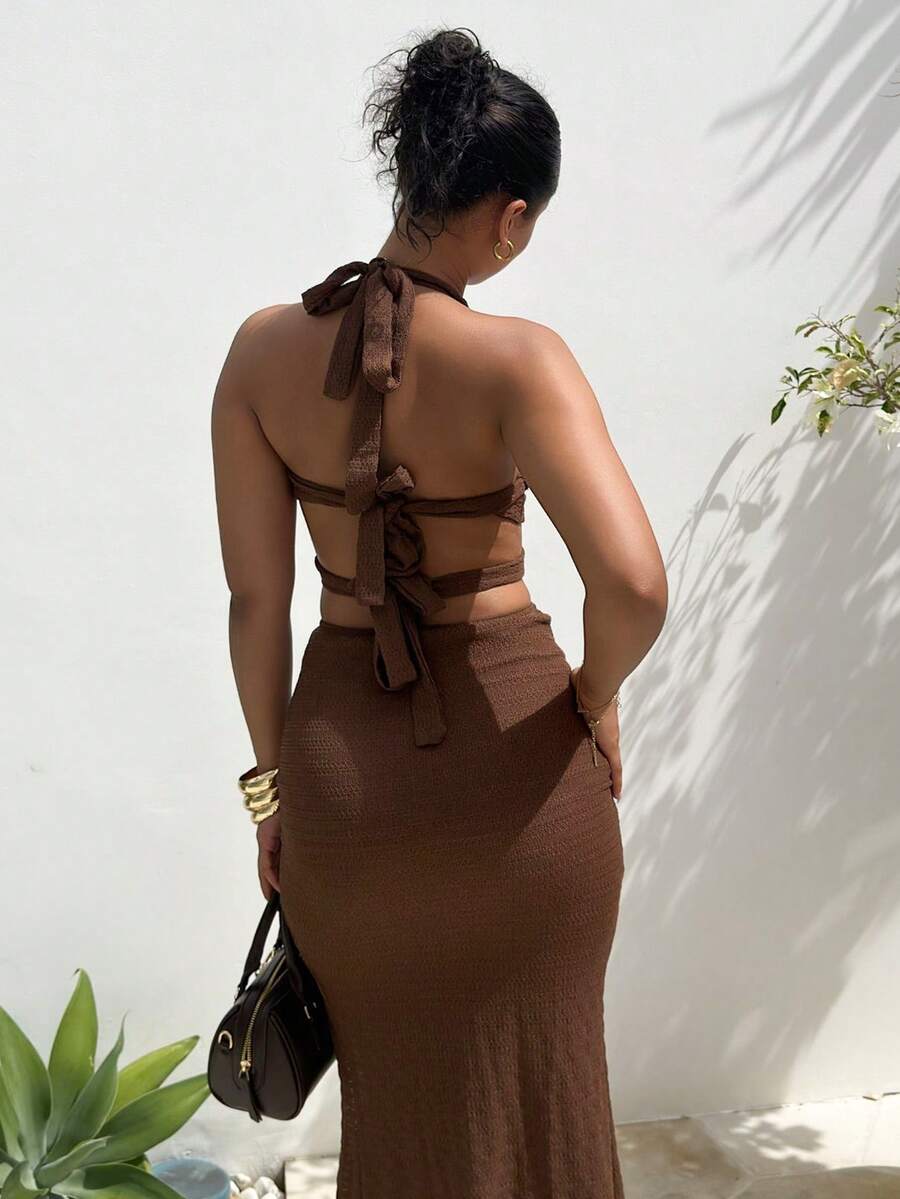 Front view of coffee halter cut out maxi dress with wrap waist straps and center hardware