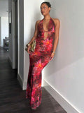 Front full body view of red tropical print halter cutout maxi dress