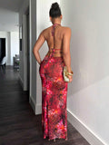Back full body view of red tropical print backless halter maxi dress with tie straps