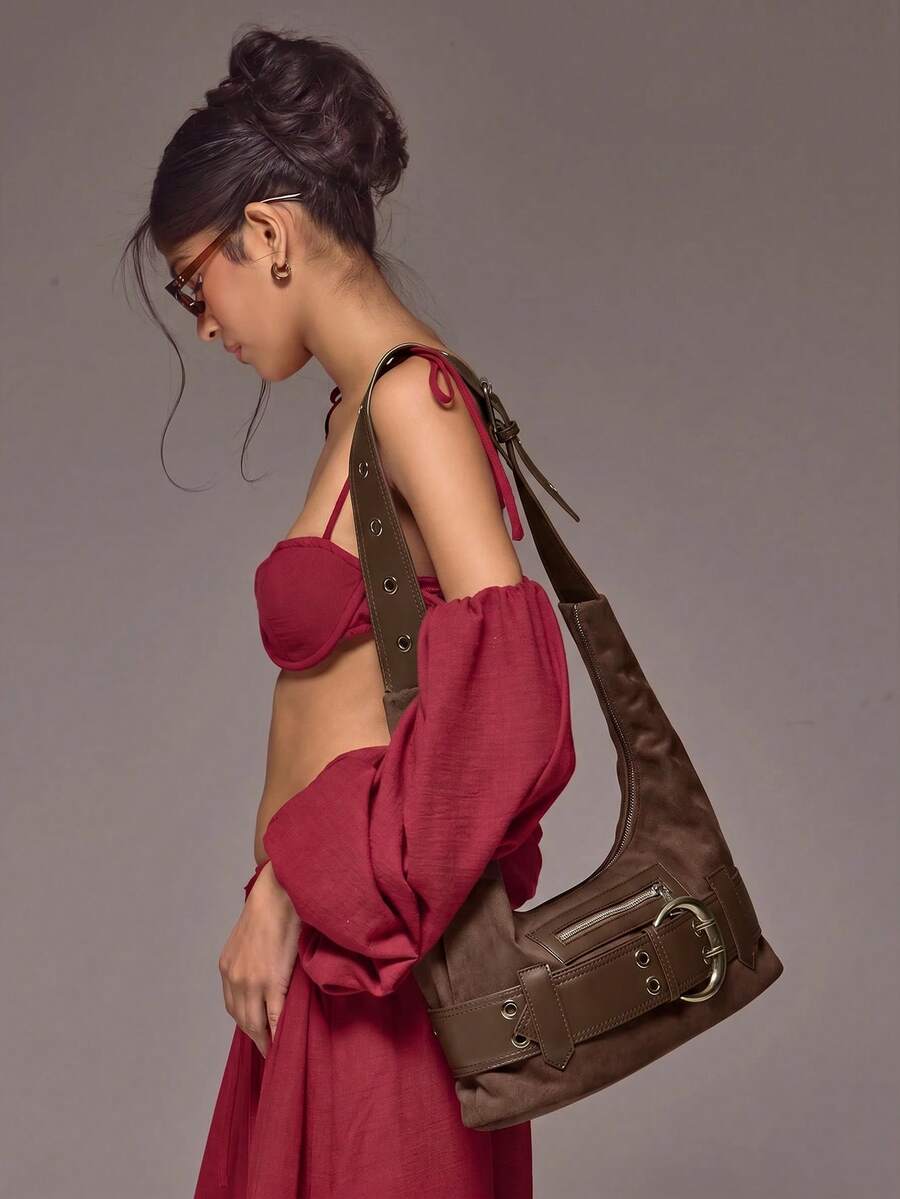 Brown crescent hobo bag with adjustable strap and front zipper pocket