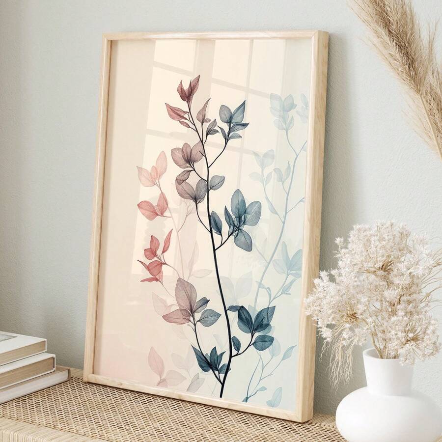 Framed botanical leaf poster leaning on woven table with dried pampas and neutral decor