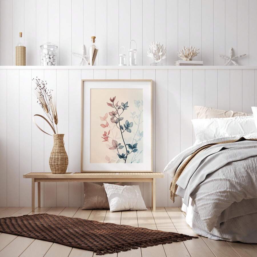 Framed botanical leaf poster leaning on woven table with dried pampas and neutral decor