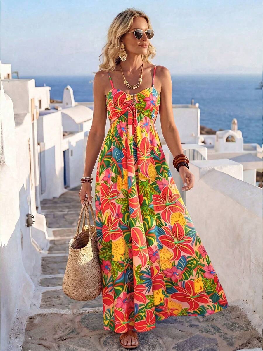 Front lifestyle view of multicolor tropical floral maxi dress in seaside vacation setting