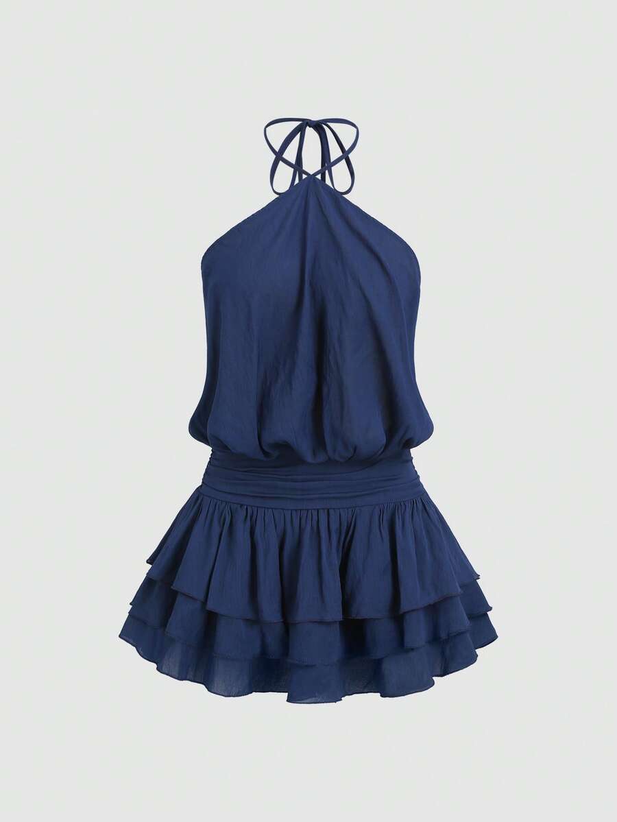 Back view of navy blue backless halter mini dress with shirred waist