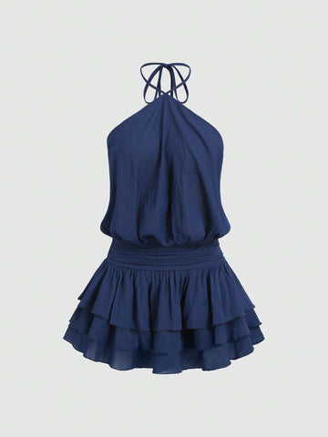 Back view of navy blue backless halter mini dress with shirred waist