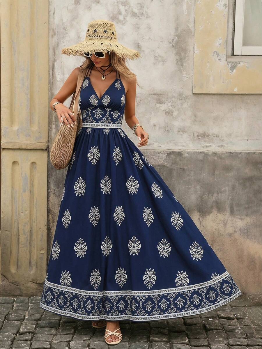 Front view of navy blue boho halter maxi dress with geometric high waist and flared skirt